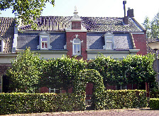 De galerie is gesitueerd in de kloosterachtige besloten achtertuin van een monumentaal pand in het historische centrum van Oirschot.