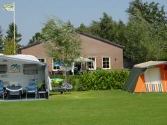 Het terrein is goed onderhouden en omringd door diverse landschappelijke beplanting.